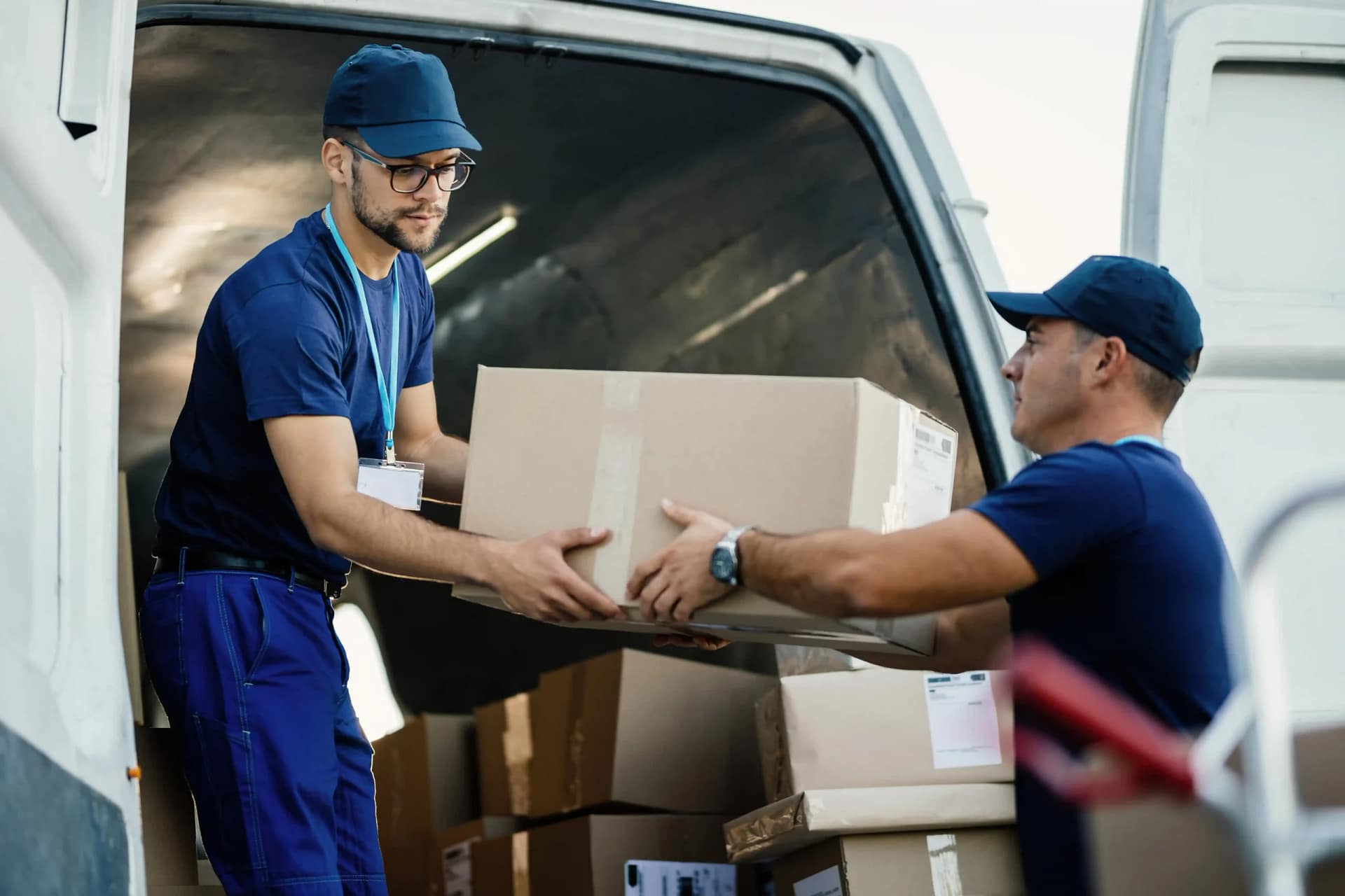delivery-men-loading-carboard-boxes-van-while-getting-ready-shipment